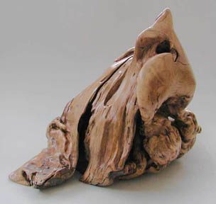 first side of three-sided wood sculpture, Simurgh, cosmic bird of Attar