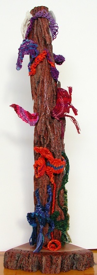 Vertical totem, eucalyptus bark slab interwoven with fibers, an energeti portrait of the family