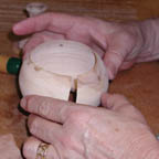Hands repairing small olive vessel in Tikkun Olam series
